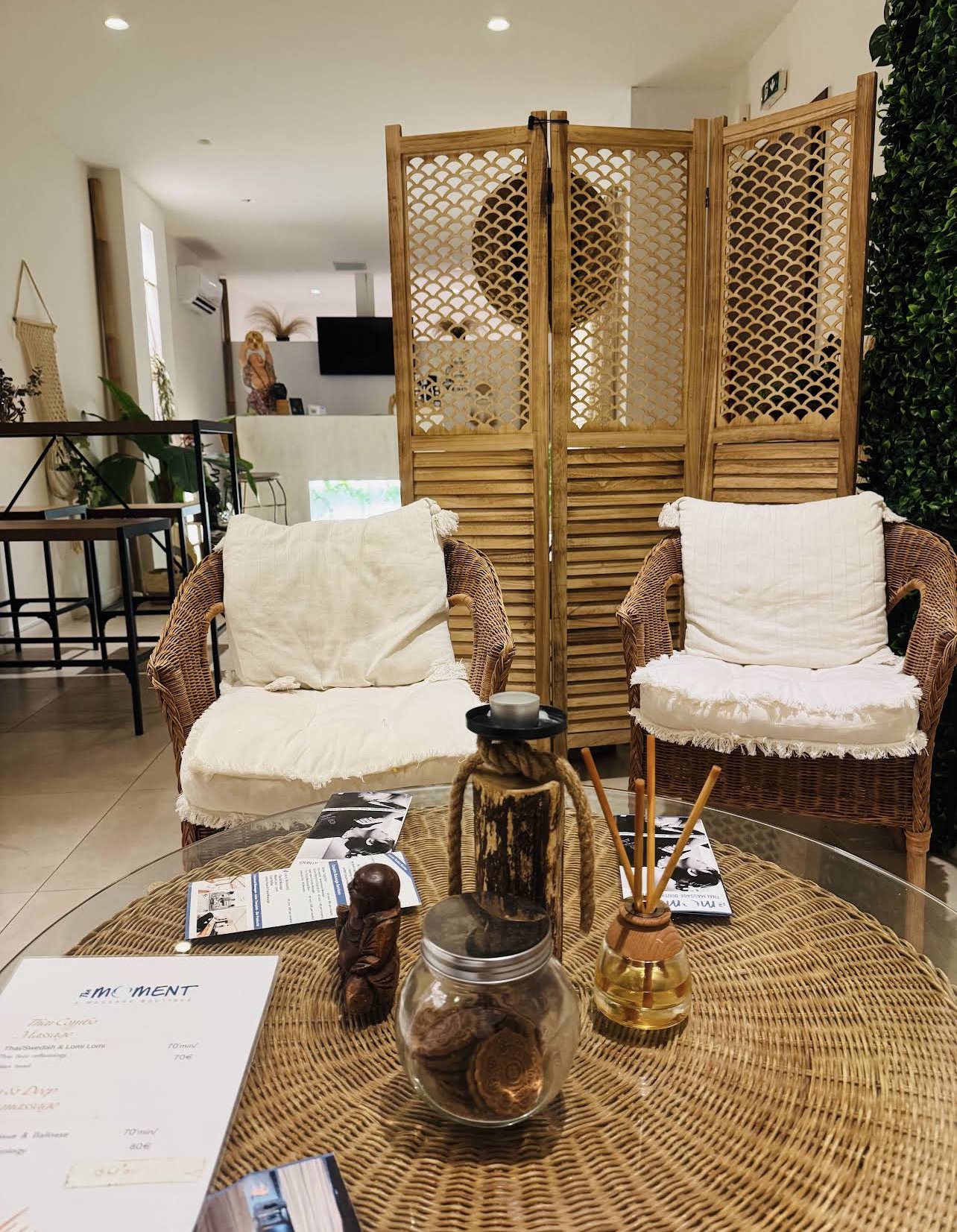 Wicker seating, aromatic oils and reception area at The Moment in Koukaki